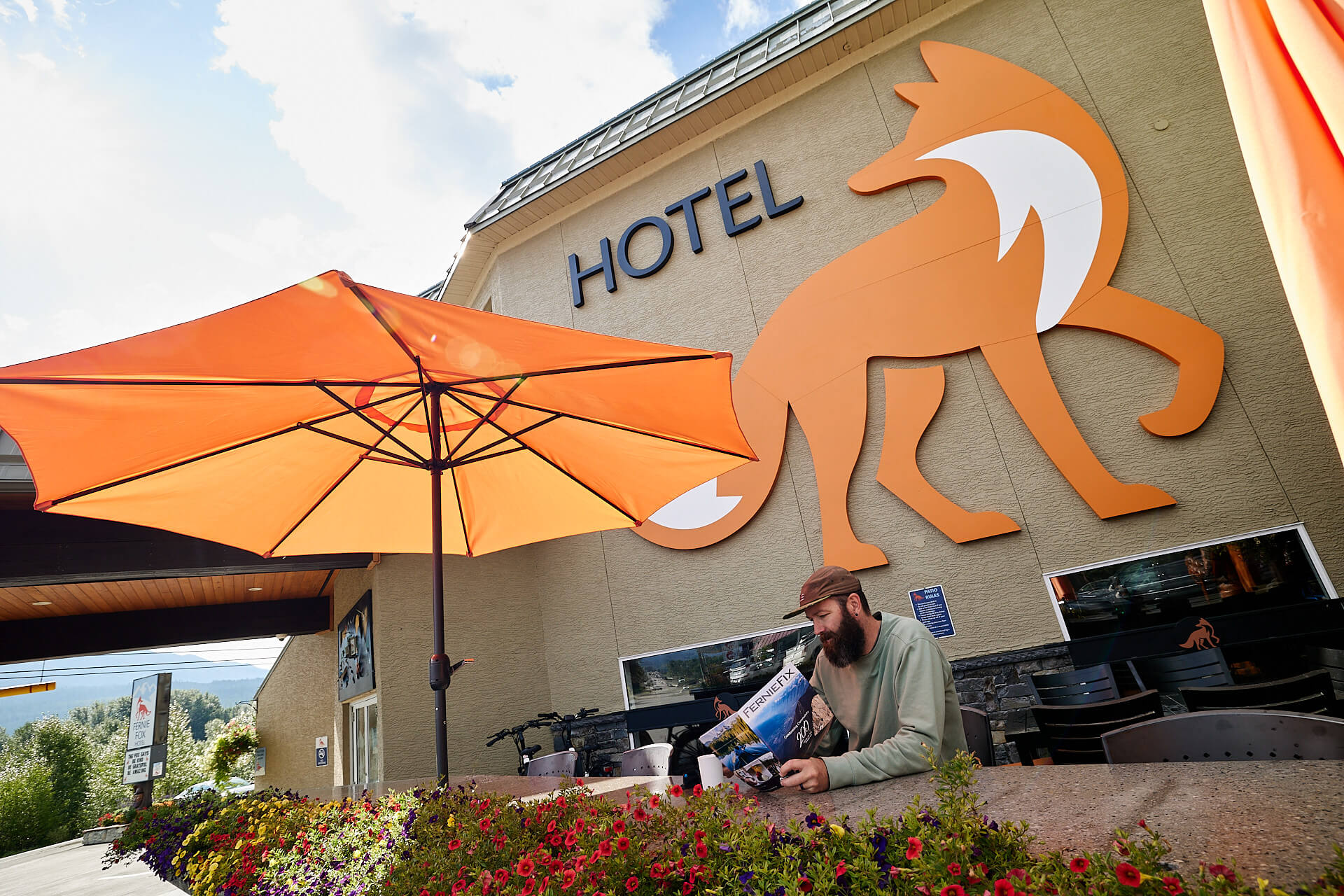 man sitting in front of Fernie Fox Hotel sign
