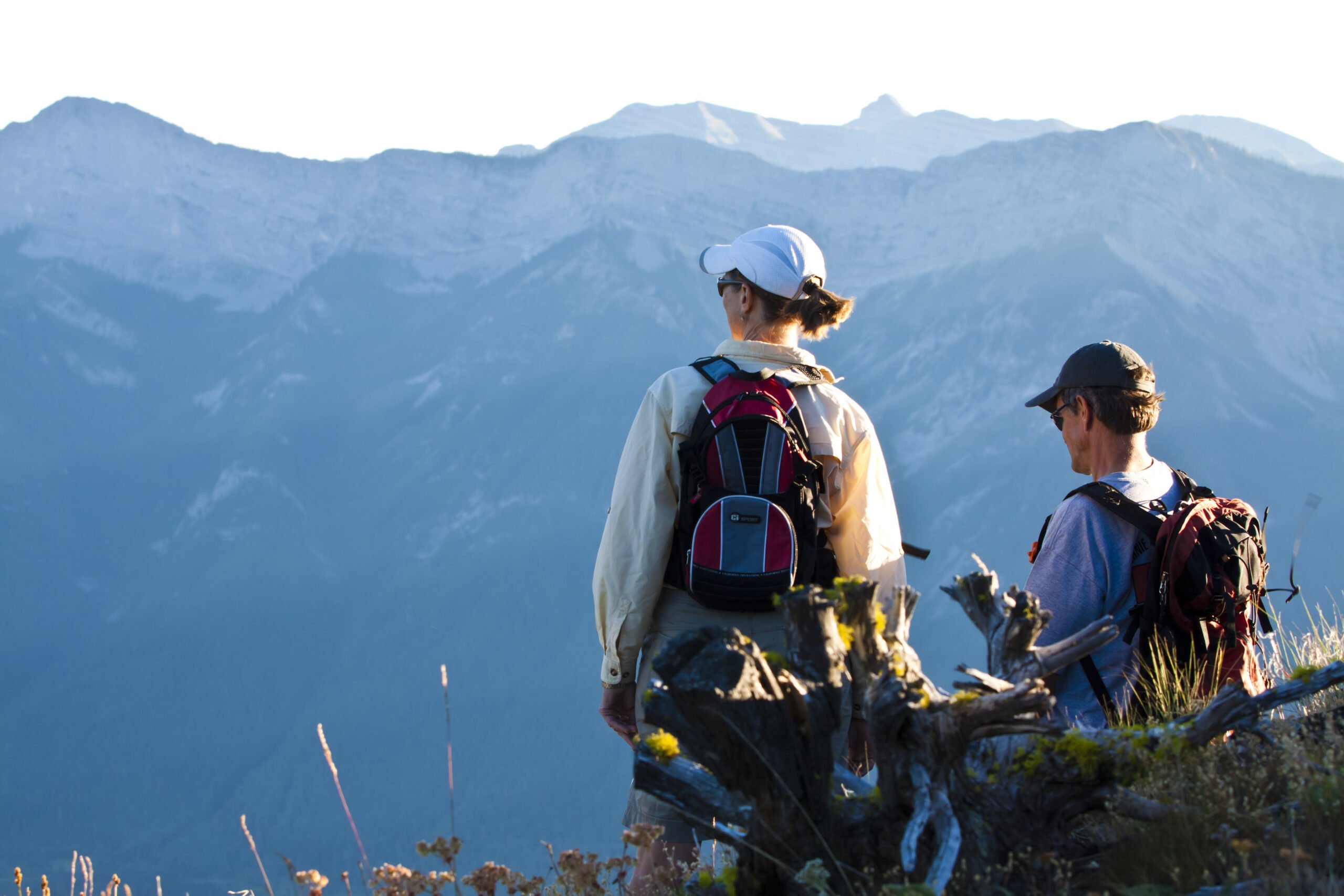 Couple resting while hiking and looking out over valley in Fernie BC
